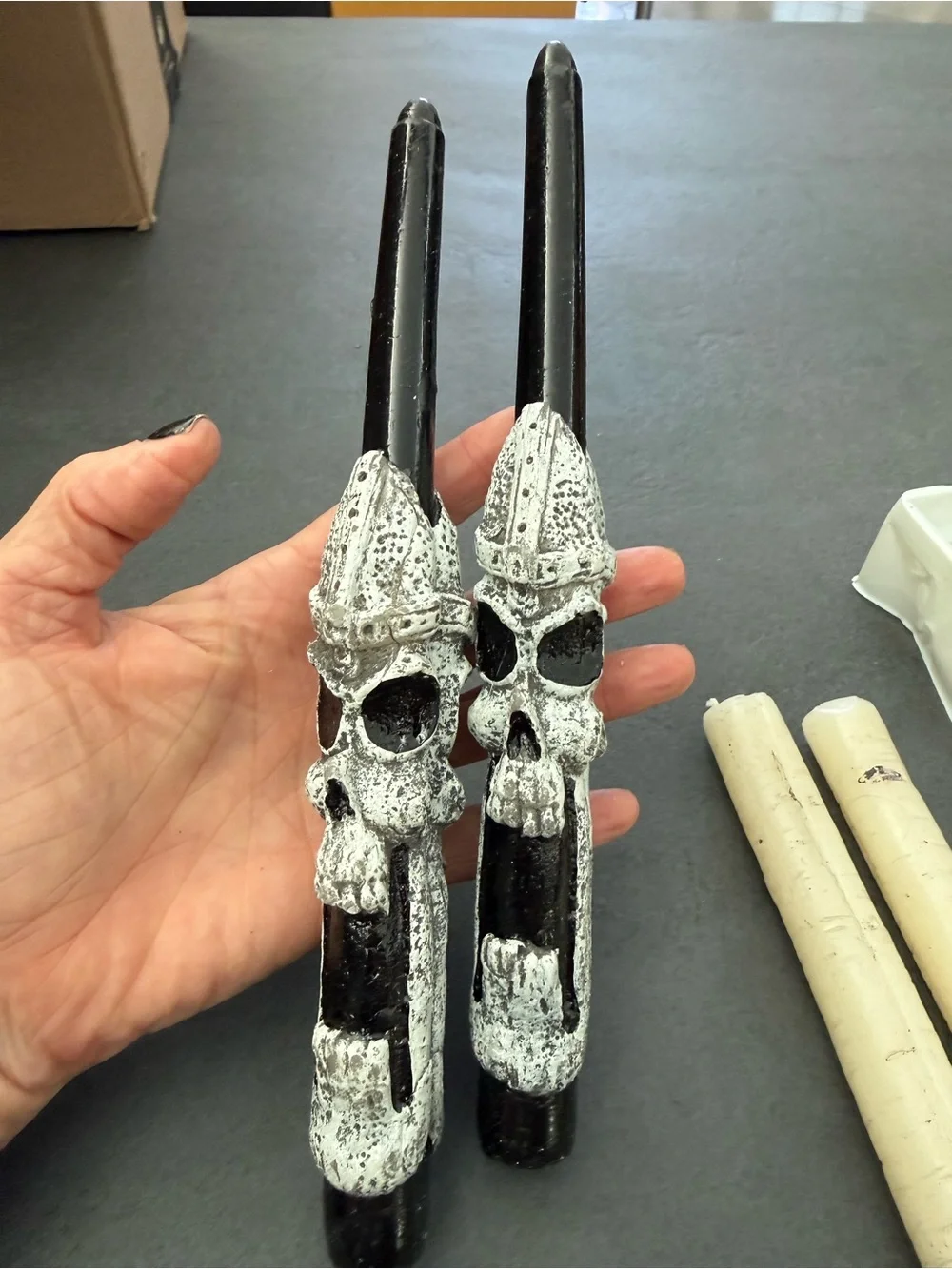 4 Halloween candles. 2 Black Skull and 2 spooky wood grain